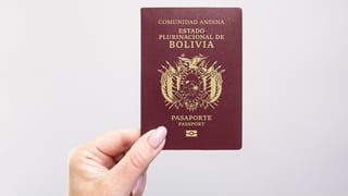 close up of a bolivia passport held in hand close up of a bolivia passport held in hand