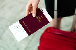 woman with passport and airline tickets at an airport woman with passport and airline tickets at an airport