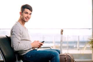 handsome smiling man in casual wear holding his luggage handsome smiling man in casual wear holding his luggage