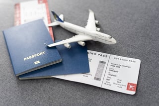 toy airplane and passport with tickets on gray background toy airplane and passport with tickets on gray background