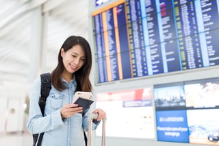 young woman using cellphone in airport young woman using cellphone in airport