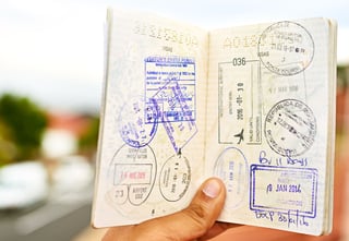 Young Man Holding Open A Passport Young Man Holding Open A Passport
