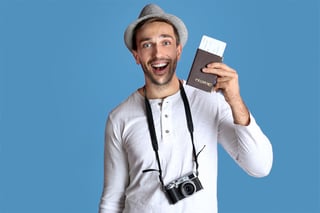 Young Man With Camera And Ticket On Blue Background Young Man With Camera And Ticket On Blue Background