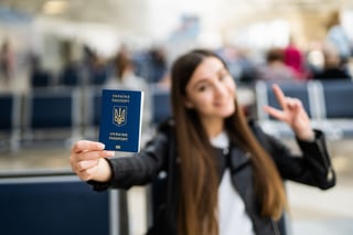 Young Woman Holding Ukraine Passport In Terminal Young Woman Holding Ukraine Passport In Terminal