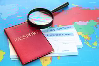 Magnifying Glass And Passport With Arrival Cards Of Immigration Bureau Magnifying Glass And Passport With Arrival Cards Of Immigration Bureau
