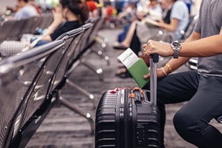 People Sitting And Waiting For Check In At Airport A Man And Luggage People Sitting And Waiting For Check In At Airport A Man And Luggage