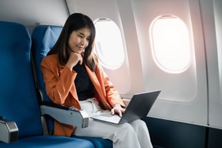 Professional Woman Working On A Laptop During A Flight Showcasing Professional Woman Working On A Laptop During A Flight Showcasing
