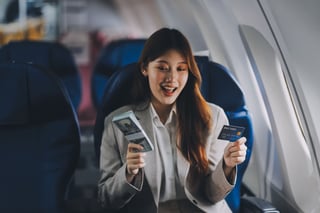 Young Businesswoman Holding Credit Card Near Blurred Young Businesswoman Holding Credit Card Near Blurred