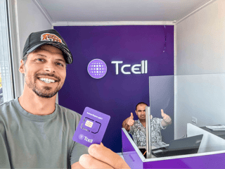 man holding a T cell SIM CARD man holding a T cell SIM CARD