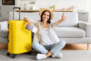 Happy Woman Sitting Near Suitcase Holding Flight Tickets Happy Woman Sitting Near Suitcase Holding Flight Tickets