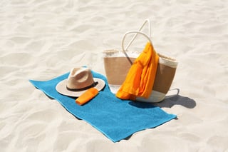 blue-towel-bag-and-accessories-on-sandy-beach