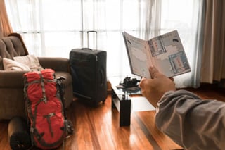 Checking passport stamp in front of travel luggage Checking passport stamp in front of travel luggage