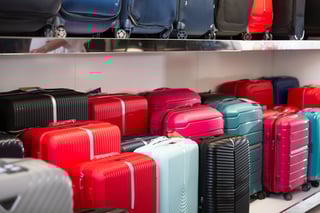 Colorful suitcases displayed on shelves Colorful suitcases displayed on shelves
