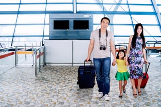 Family walking with luggage in airport Family walking with luggage in airport