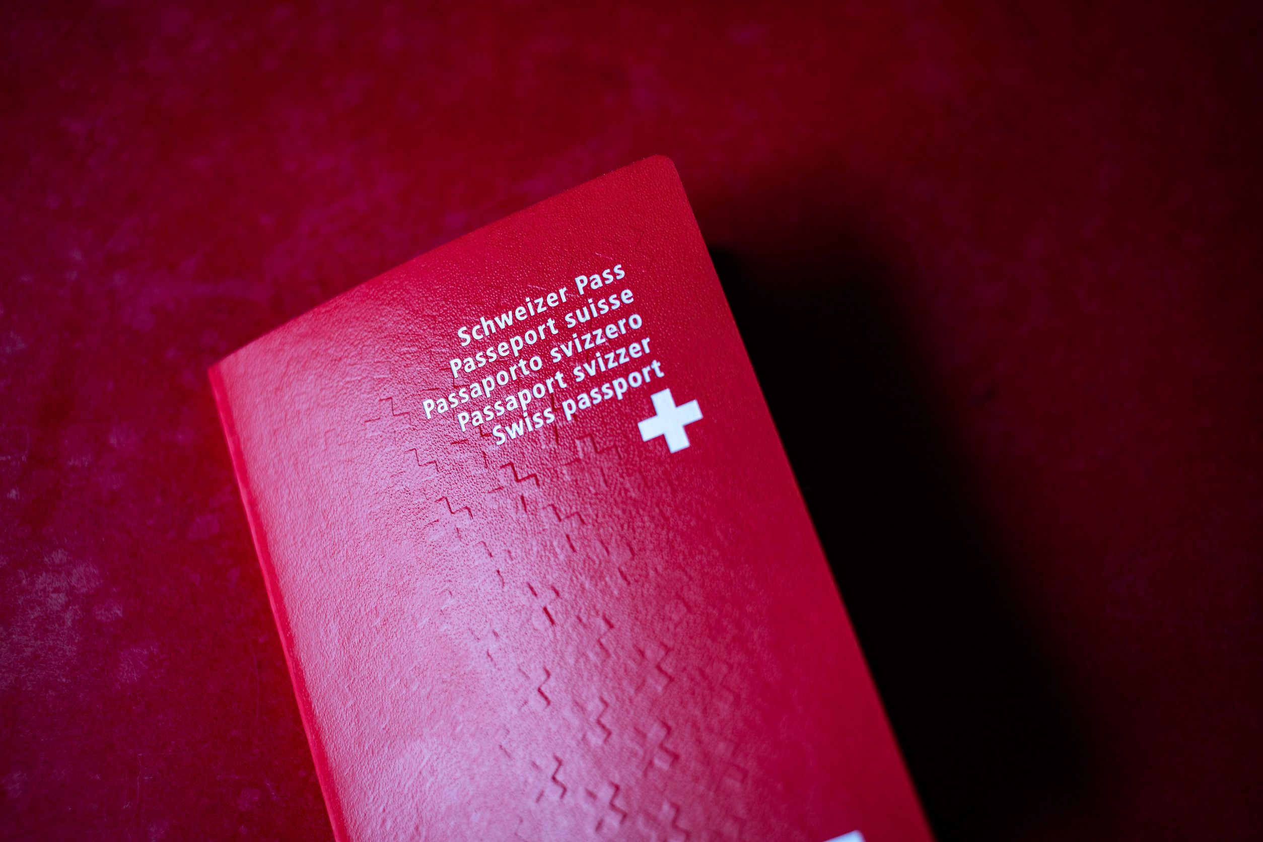 Swiss passport on red background Swiss passport on red background