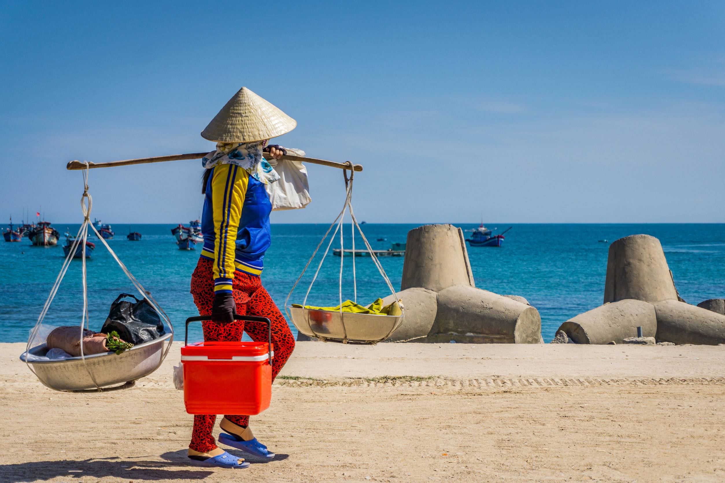 Woman brings basket in beach Woman brings basket in beach